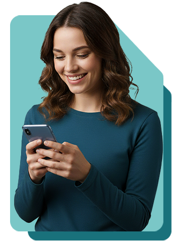 Smiling woman in a colourful floral dress looking down at and using her smartphone against a teal background.